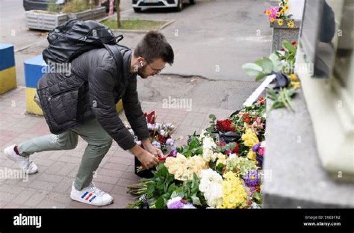 A man leaves flowers outside the mall
