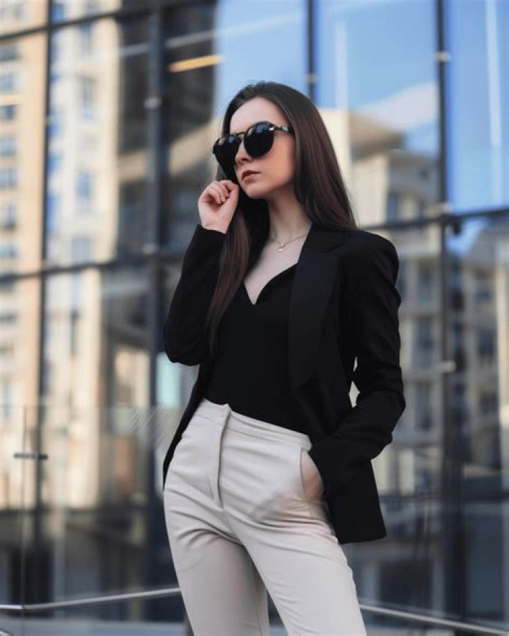 A woman wearing cream pants.