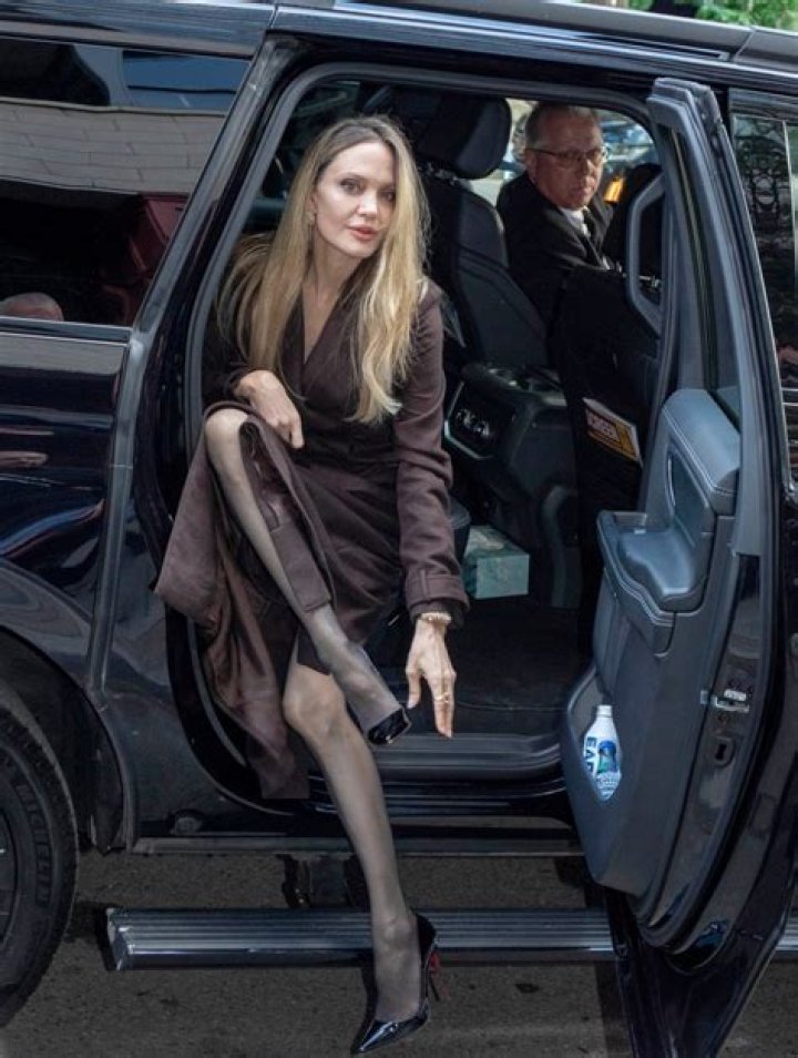 Angelina Jolie showing thigh in a slit skirt