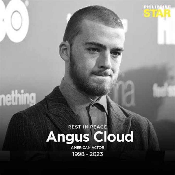 Angus Cloud giving peace signs