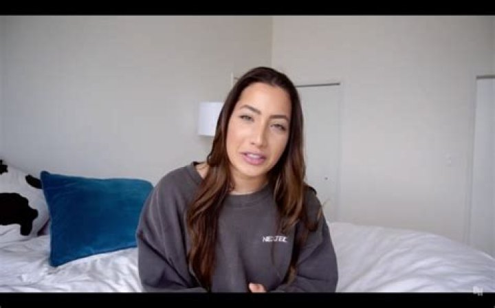 Brooke Houts sitting on a bed
