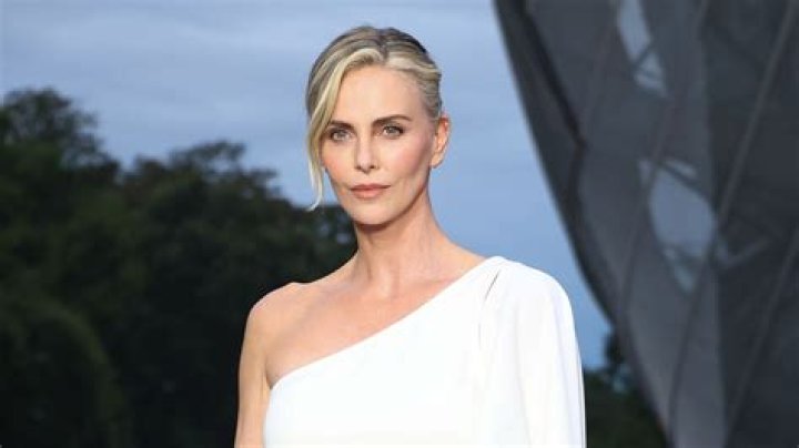 Charlize Theron Stuns In A Red Tank Top & Jeans