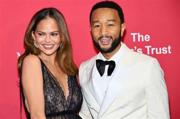 Chrissy Teigen Stuns In Purple Sari As She & Husband John Legend Celebrate Diwali