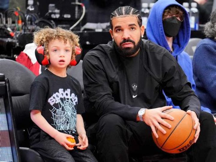 Drake and his son Adonis at a basketball game
