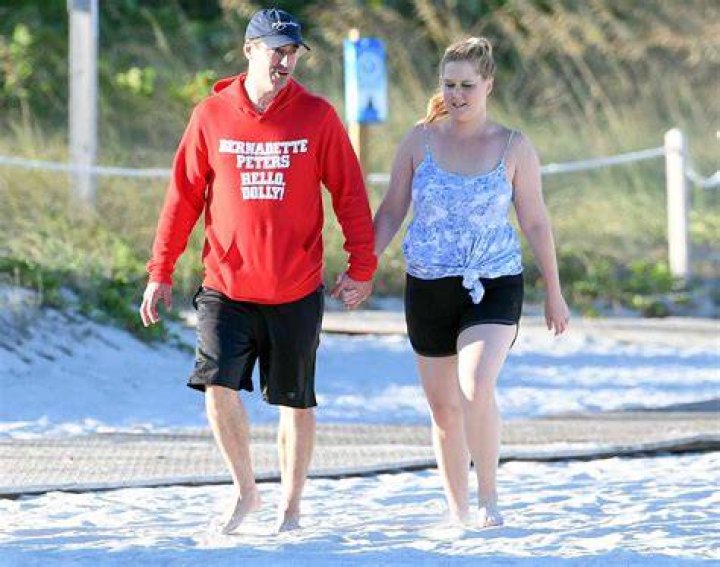 EXCLUSIVE: Newlyweds Amy Schumer and Chris Fischer laugh and hold hands as they take a walk along the beach in Miami. 03 Apr 2018 Pictured: Amy Schumer; Chris Fischer. Photo credit: MEGA TheMegaAgency.com +1 888 505 6342 (Mega Agency TagID: MEGA193928_015.jpg) [Photo via Mega Agency]