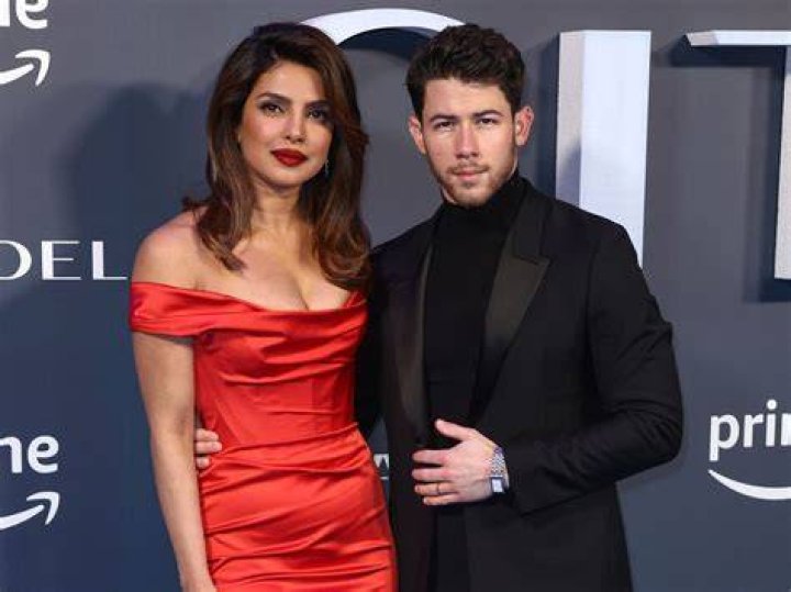 EXCLUSIVE: Nick Jonas and wife Priyanka Chopra Jonas go sightseeing around London ahead of the Christmas holidays. The couple, who have been married for two years, wore face masks and stopped for a hot drink at a cafe. The Bollywood actress who is in town to film 'Text for You', looked positively glowing. The happy couple could be seen stopping for Nick to take some funny photos of Priyanka next to a Highway Maintenance van, presumably to have the words &lsquo;High Maintenance&rsquo; behind her. The loved up pair could be seen walking along with Priyanka&rsquo;s mother in tow, always a couple of yards behind them. Nick, 28, and Priyanka, 38, could be seen wearing Christmas colors, with Nick in a green beanie hat and green accented checked woolen overcoat, while Priyanka opted for a dark brown leather jacket with red and pink knitted top, beanie hat, and jeans. 09 Dec 2020 Pictured: Nick Jonas, Priyanka Chopra Jonas. Photo credit: MEGA TheMegaAgency.com +1 888 505 6342 (Mega Agency TagID: MEGA720310_003.jpg) [Photo via Mega Agency]