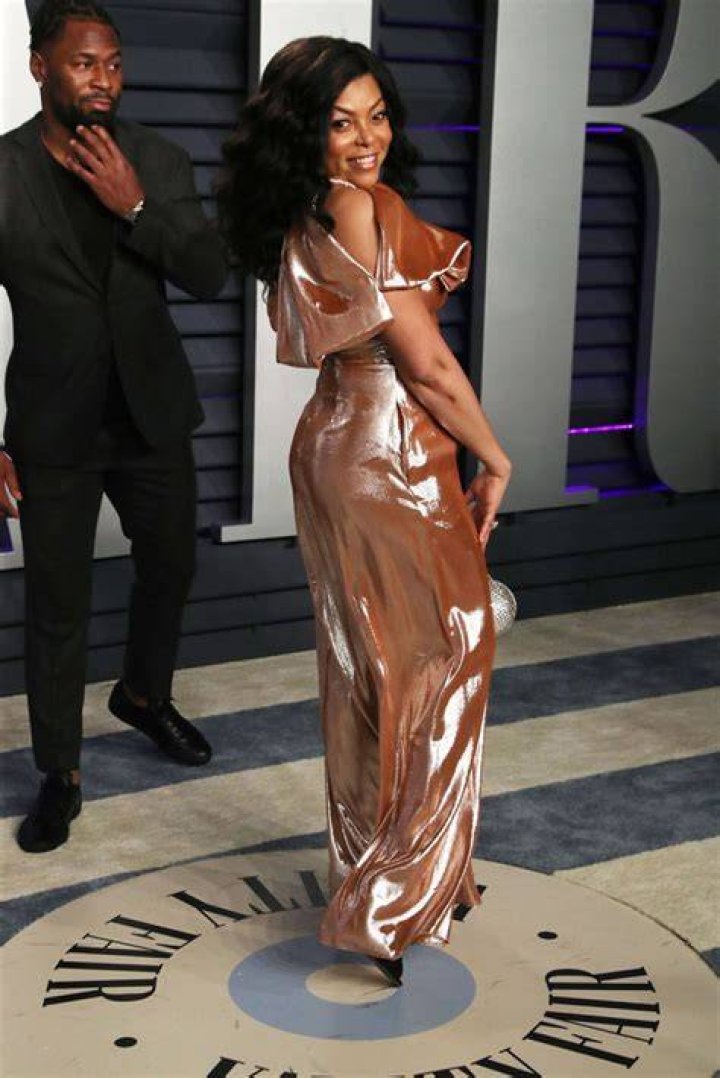Kelvin Hayden stands back as Taraji P. Henson poses at the Vanity Fair Oscar Party