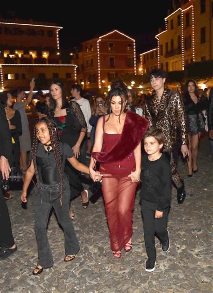 Kourtney Kardashian holds hands with Reign