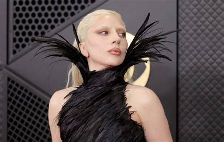 Lady Gaga poses in a white dress