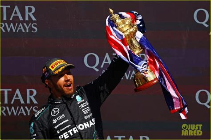 Lewis Hamilton holds his championship trophy