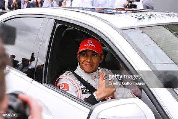 Lewis Hamilton smiles for the cameras