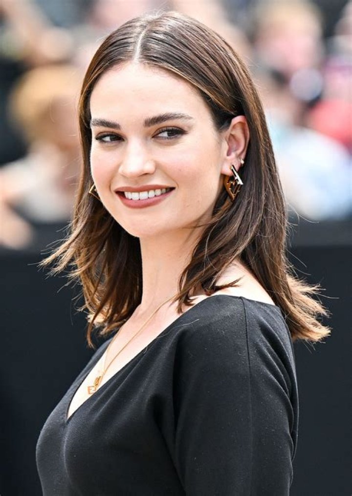 Lily James heads to the set of 'Pam & Tommy' wearing a platinum blonde wig and flirty white dress in Los Angeles, California. The British actress who is playing Baywatch bombshell Pamela Anderson in the upcoming Hulu series, was heading back to set after lunch. Onlookers caught a glimpse of her white minidress but the 32-year-old mostly covered up in a black robe and stayed comfortable in a pair of Nike slides. She stars opposite Sebastian Stan, who plays Tommy Lee in the hotly anticipated drama, which focuses on the Hollywood duo's sex tape scandal. Pictured: Lily James Ref: SPL5225013 030521 NON-EXCLUSIVE Picture by: SplashNews.com Splash News and Pictures USA: +1 310-525-5808 London: +44 (0)20 8126 1009 Berlin: +49 175 3764 166 World Rights