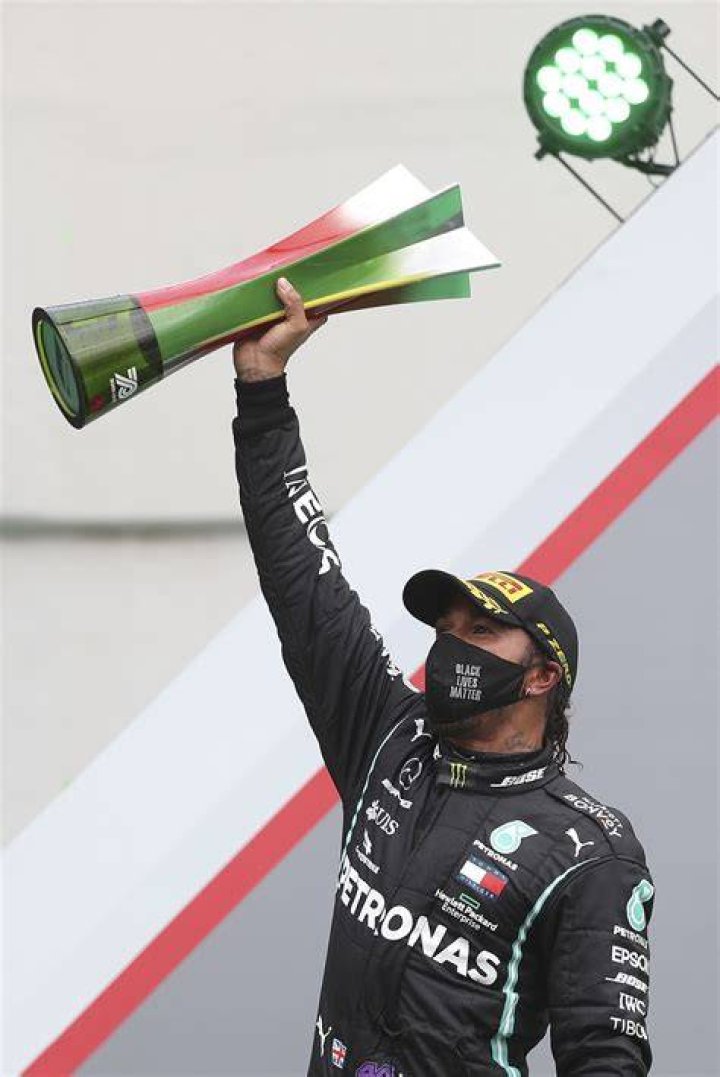 Mercedes driver Lewis Hamilton of Britain celebrates after winning the Turkish Formula One Grand Prix at the Istanbul Park circuit racetrack in Istanbul, Sunday, Nov. 15, 2020. (Clive Mason/Pool via AP)