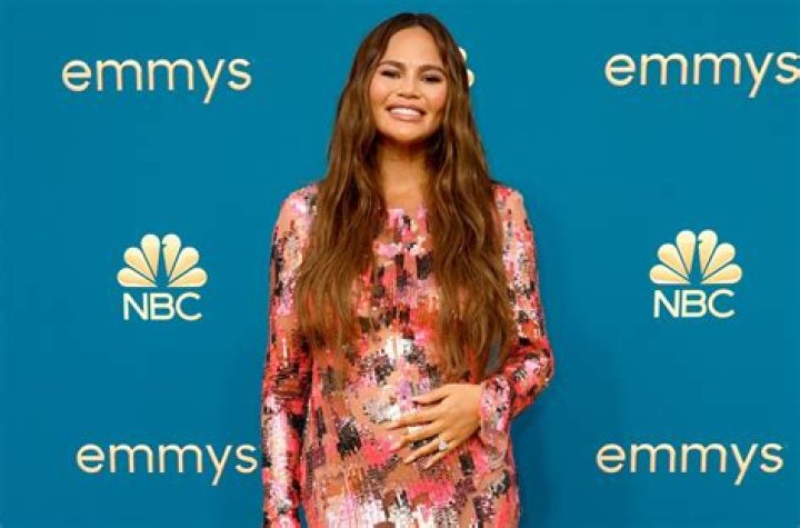 Pregnant Chrissy Teigen Shows Off Her Bare Baby Bump While Poolside In A String Bikini