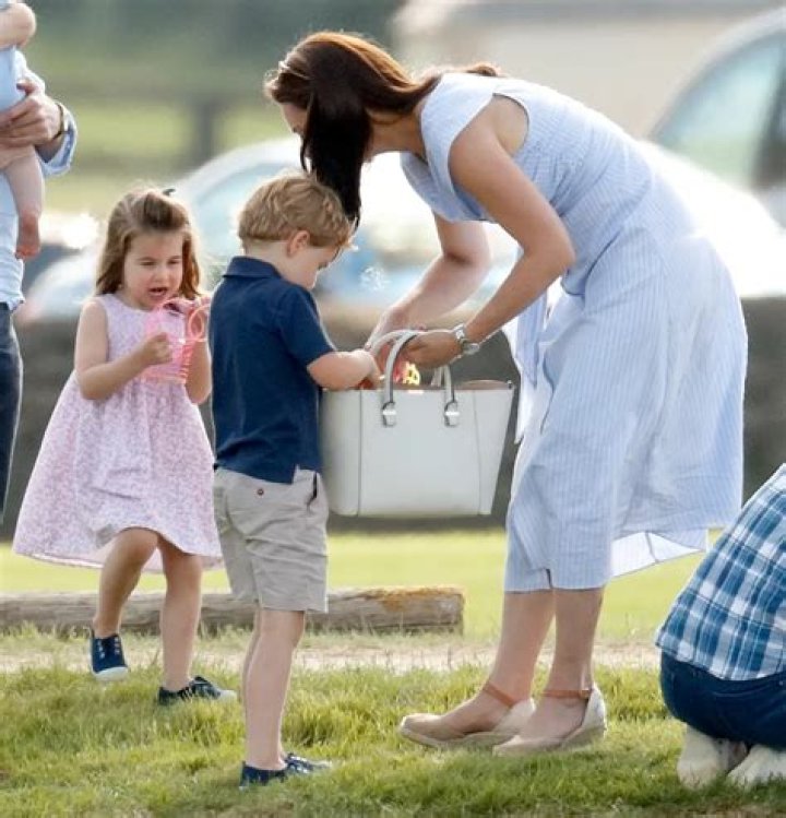 Princess Charlotte does a headstand outside