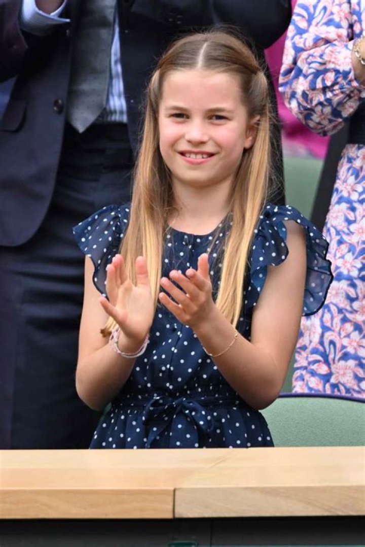 Princess Charlotte sits on the ground