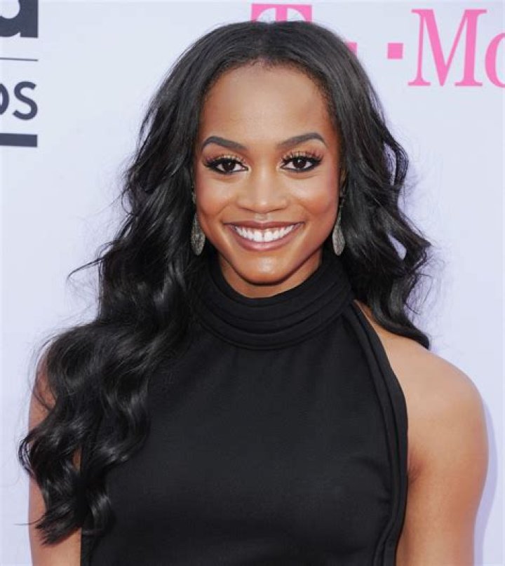 Rachel Lindsay smiles as she wears hoop earrings