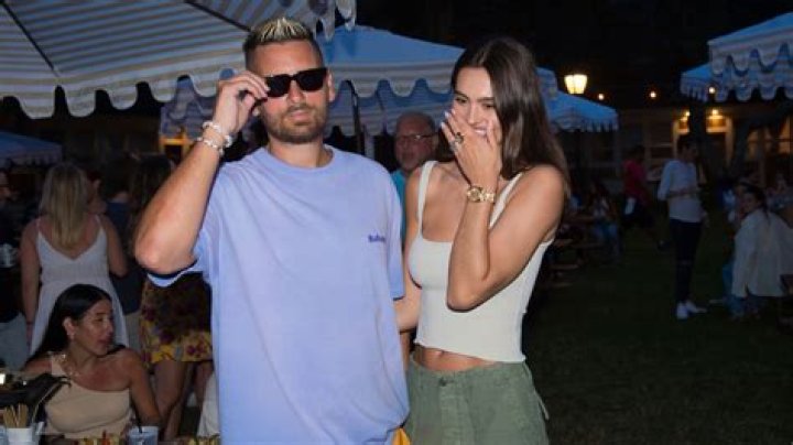 Scott Disick and girlfriend Amelia Hamlin color coordinate in orange hues as they take a stroll along the beach in Miami. 07 Apr 2021 Pictured: Scott Disick; Amelia Hamlin. Photo credit: MEGA TheMegaAgency.com +1 888 505 6342 (Mega Agency TagID: MEGA744807_001.jpg) [Photo via Mega Agency]