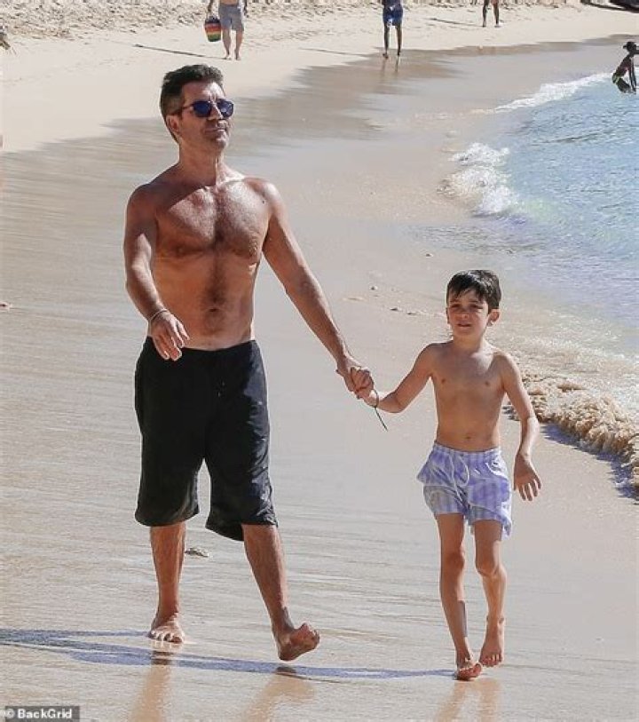 Simon Cowell, 60, Looks Buff As He Goes Shirtless On The Beach With Son Eric, 7, & Lauren Silverman