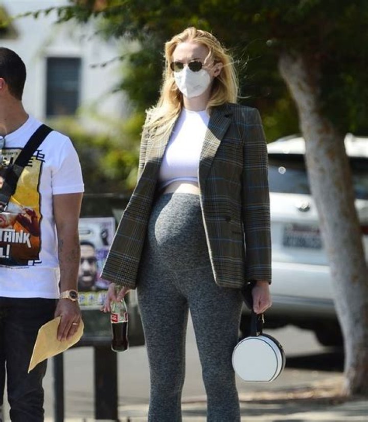 Sophie Turner Shows Off Growing Baby Bump In Skintight Black Leggings While Out With Husband Joe — See Pics