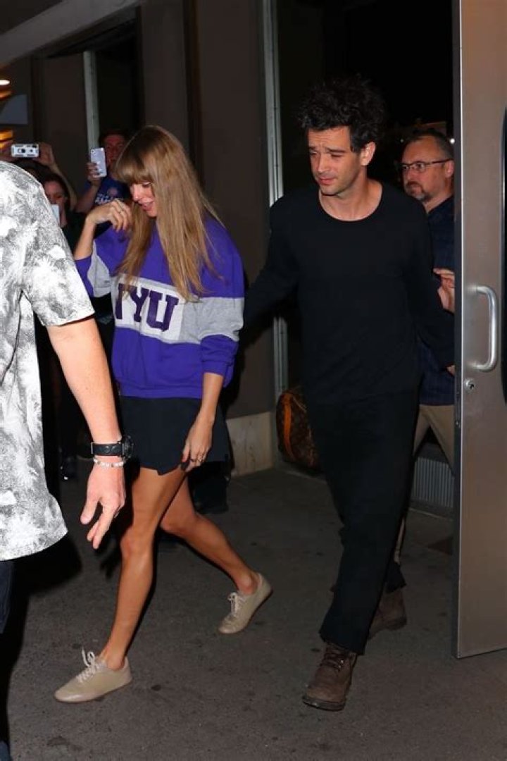 Taylor Swift walking with Matty Healy out of a party