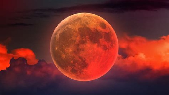 The full moon shines red behind a high tension wire near Jacobsdorf, Germany, 20 June 2016. The arriving night was the shortest of the year. The late setting sun colored the full moon red. The natural phenomenon is called 'strawberry moon.' Photo by: Patrick Pleul/picture-alliance/dpa/AP Images
