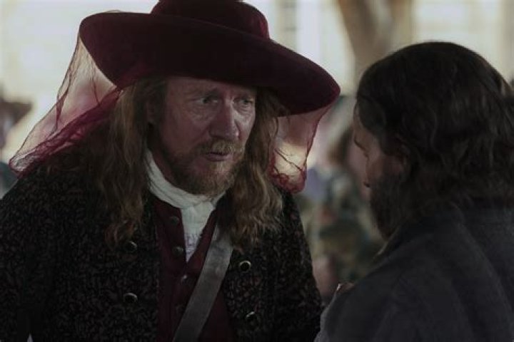 Trepagny (David Thewlis) speaks to Rene Sel (Christian Cooke) in the Trade Hall in Wobik. (National Geographic/Peter H. Stranks)