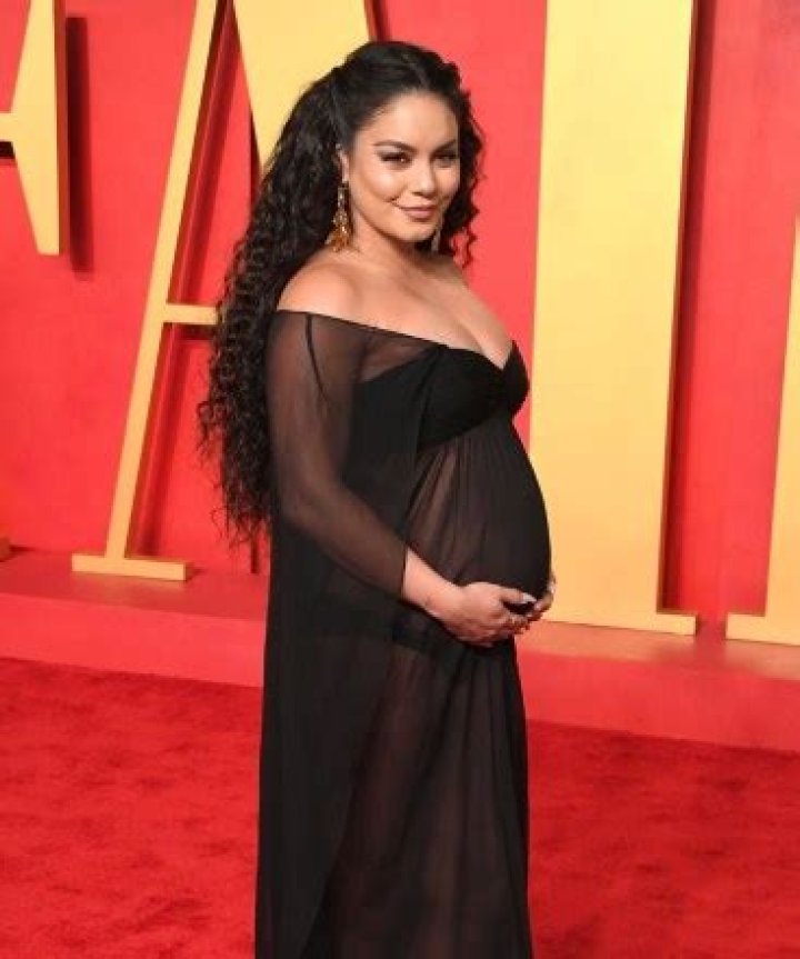 Vanessa Hudgens Cradles Baby Bump in a Stylish Brown Dress: See Photo